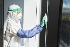 Female worker cleaning windows