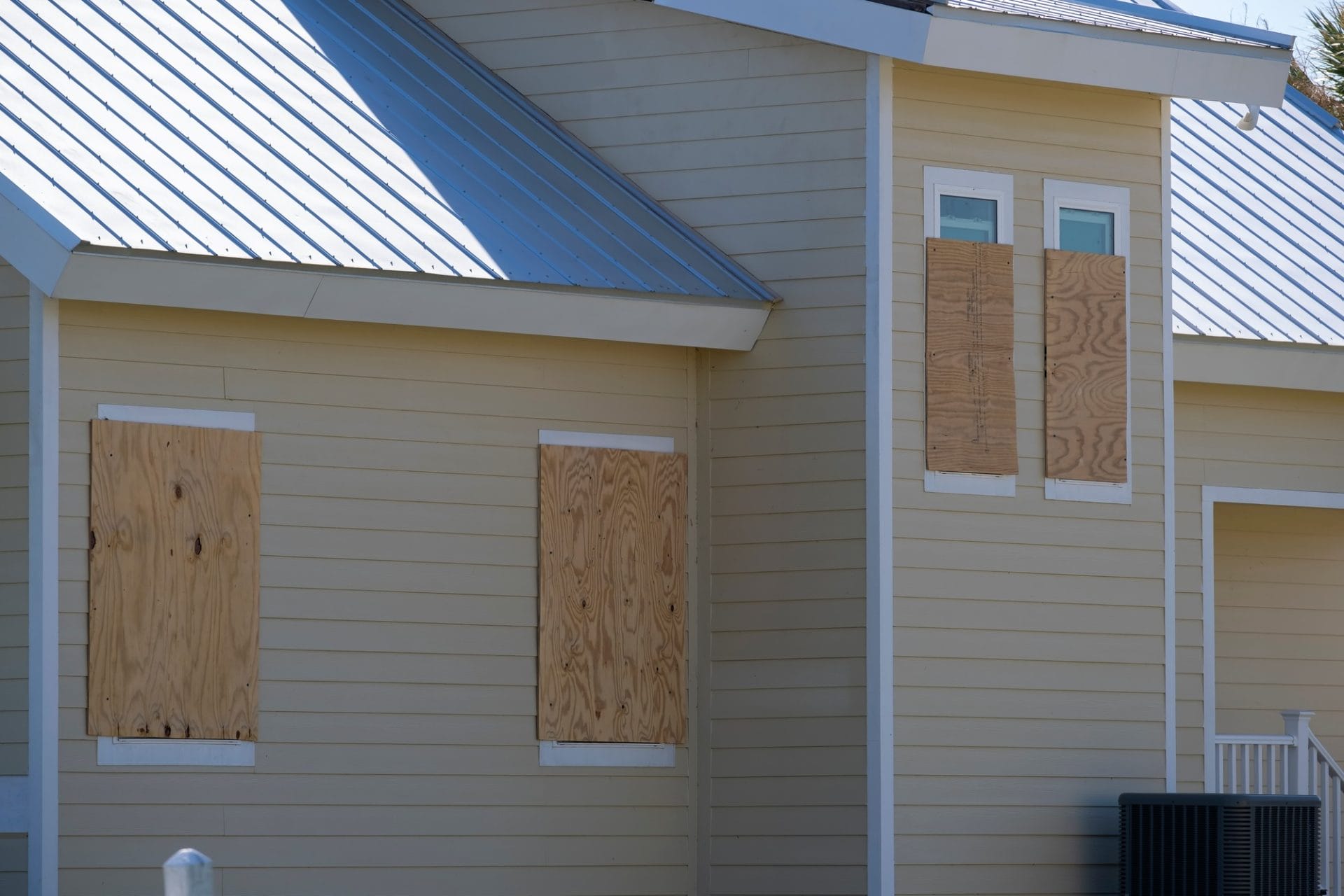 Boarded up windows with plywood storm shutters for hurricane protection